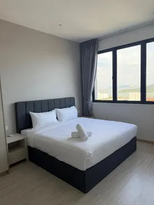 a bedroom with a large bed with a large window at Homey Studio Unit Relaxing Stay at Bayan Lepas in Gua Sai