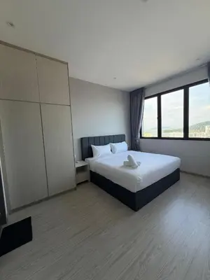 a bedroom with a bed and a large window at Homey Studio Unit Relaxing Stay at Bayan Lepas in Gua Sai