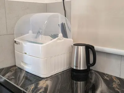 a kitchen counter with a sink and a coffee pot at Piccadilly Residence Greentown in Ipoh