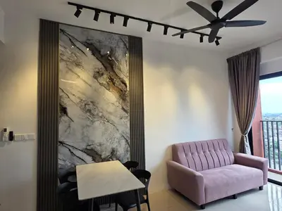 a living room with a pink couch and a table at Piccadilly Residence Greentown in Ipoh