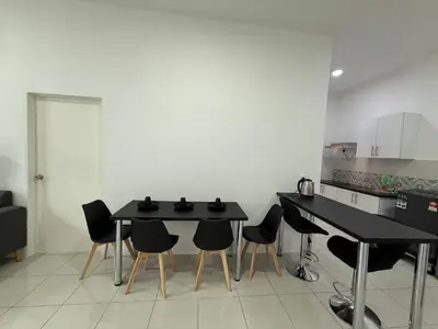 a kitchen with black tables and chairs in a room at 3pax Suite Ipoh Town The Anderson Residence #147 in Ipoh