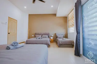 a bedroom with three beds and a window at Ipoh Summer Suite by Veve EECH05 in Gua Sai