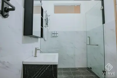a bathroom with a sink and a glass shower at Ipoh Summer Suite by Veve EECH05 in Gua Sai