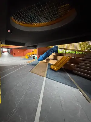 an empty playground with a slide in a building at Piccadilly Greentown by Jun Residence in Ipoh