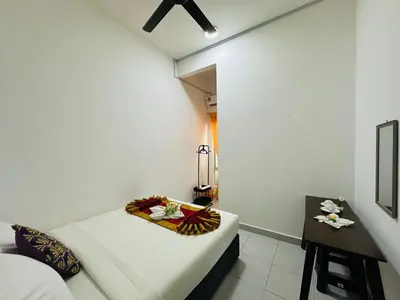 a small room with a bed and a table at Raub Colonial 208 Homestay in Raub