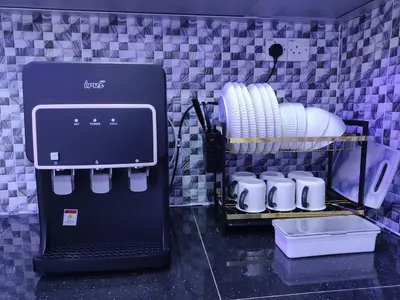 a coffee maker in a kitchen with a rack of plates at Cozyhaus Stay Sanctuary-Netflix-Pool- 1 Parking in Taiping