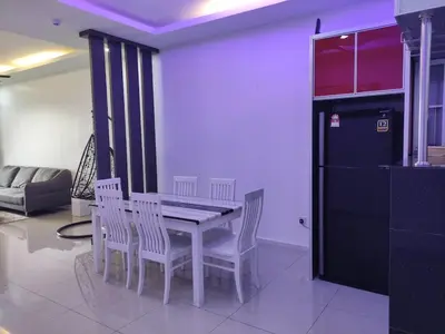 a dining room with a white table and chairs at Cozyhaus Stay Sanctuary-Netflix-Pool- 1 Parking in Taiping