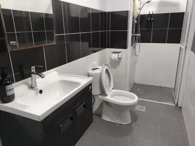 a bathroom with a sink and a toilet and a shower at Cozyhaus Stay Sanctuary-Netflix-Pool- 1 Parking in Taiping