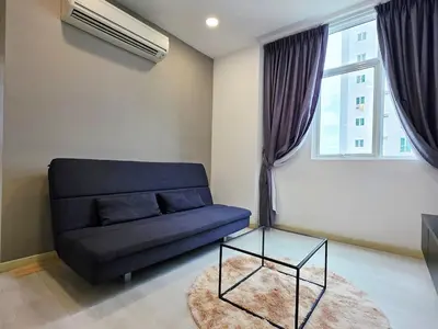 a living room with a blue couch and a window at StayLuxe SGS 2BR Suite in George Town