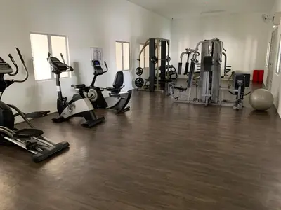 a gym with several treadmills and exercise bikes at B-Ulike-HomeStay-3Room-TheVenus in Sitiawan