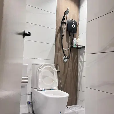 a small bathroom with a toilet and a shower at Piccadilly Green Town Luxury Stay, Ipoh in Ipoh