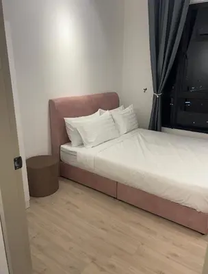 a bedroom with a bed with white pillows at Piccadilly Green Town Luxury Stay, Ipoh in Ipoh