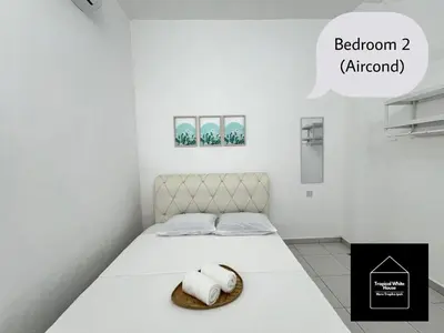a bedroom with a bed with two towels on it at Ipoh Musllim Homestay Meru Tropika - 3 Bedrooms in Ipoh