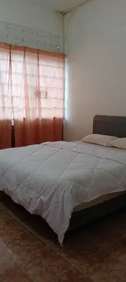 a bedroom with a large bed with a window at D Seberang Homestay in Perai