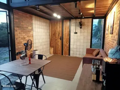 a living room with a table and a couch at Tepian Sawah Semanggol in Simpang Ampat Semanggol