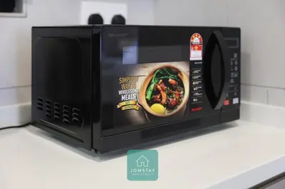 a microwave with a picture of a curry inside at JOMSTAY - Piccadilly Greentown Ipoh in Ipoh