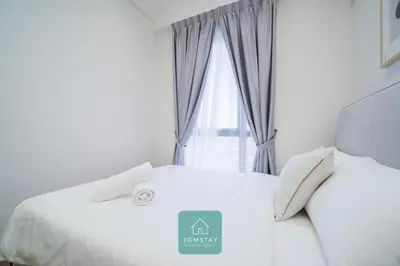 a bedroom with a white bed with a window at JOMSTAY - Piccadilly Greentown Ipoh in Ipoh