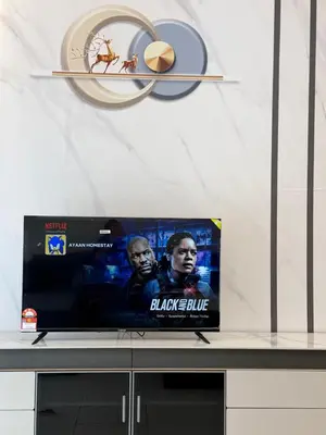 a flat screen tv sitting on top of a table at Ayaan Platinum2 Homestay at Tanah Rata with Private Parking and Air Hockey Games in Tanah Rata