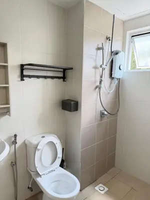 a bathroom with a shower and a toilet and a sink at Ayaan Platinum2 Homestay at Tanah Rata with Private Parking and Air Hockey Games in Tanah Rata