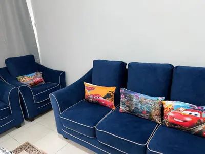 a blue couch with two pillows on it at AYAAN McQUEEN Featured House with ps3 experience Most Wanted 2012 Racing games in Tanah Rata