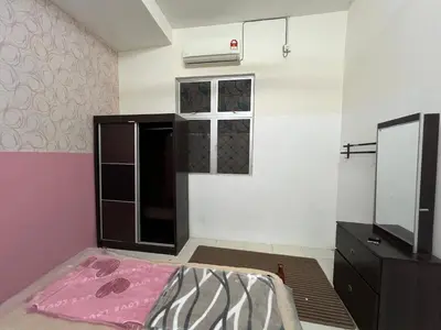 a small room with a bed and a dresser at Homestay Adelia SI in Seri Iskandar