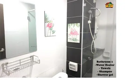 a bathroom with a shower with a mirror and a sink at H2H- Dreamy Home - Majestic Ipoh - 7 pax in Ipoh