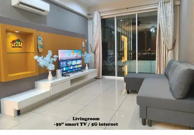a living room with a couch and a tv at H2H- Dreamy Home - Majestic Ipoh - 7 pax in Ipoh