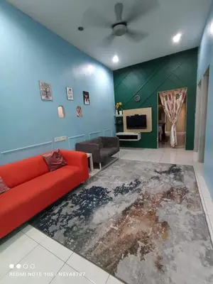 a living room with a red couch and a blue wall at De Ariffa Homestay مسلم in Lahat