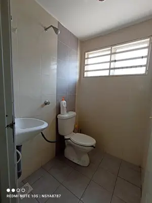 a bathroom with a toilet and a sink at De Ariffa Homestay مسلم in Lahat