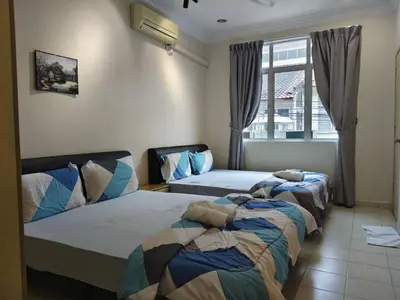a bedroom with two beds and a window at Warmy 4 Bedrooms Double Storey Homestay, Few mins to Town, by MR HOMESTAY in Teluk Intan