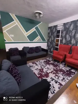 a living room with a couch and red chairs at RIADAH DALAM IBADAH by Rumah Che Matsunami in Brinchang