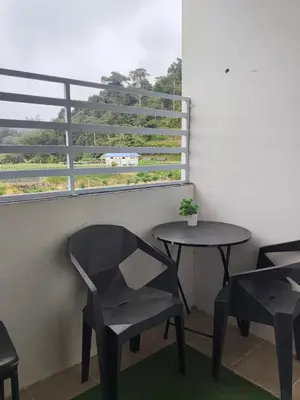 a room with two tables and two chairs and a window at RIADAH DALAM IBADAH by Rumah Che Matsunami in Brinchang