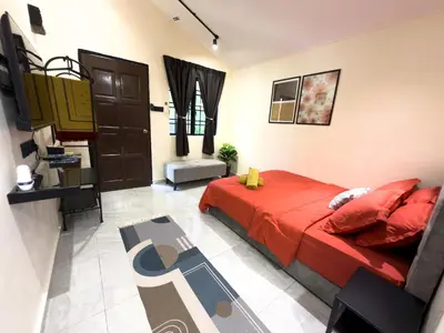 a bedroom with a red bed in a room at Swit60 Homestay in Sungai Besar