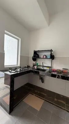 a kitchen with a sink and a window at Homestay Azizi in Seri Iskandar