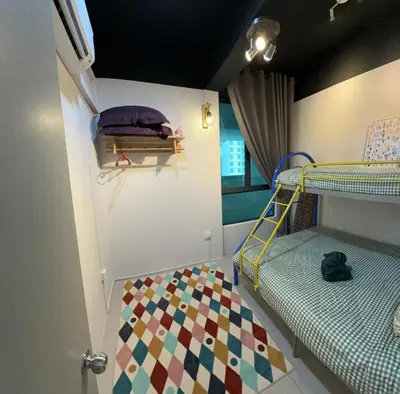 a room with two bunk beds and a rug at Idham homestay 2 in Ipoh