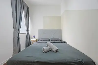 a bedroom with a bed with two pillows on it at Top 2 Palas Horizon Brinchang Cameron Highlands in Brinchang