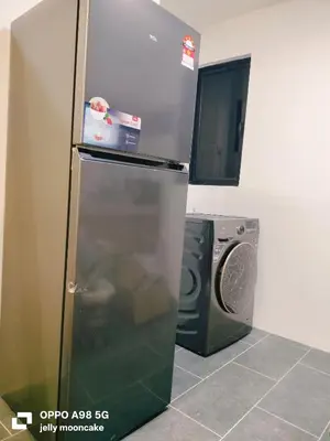 a refrigerator and a washing machine in a kitchen at LMS ipoh town in Ipoh
