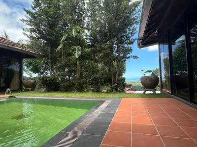 a swimming pool in the backyard of a house at Bao Sheng Durian Farm in Balik Pulau