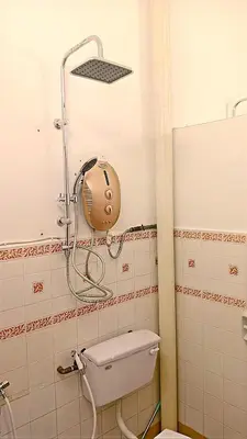 a bathroom with a toilet with a shower head at A K Homestay in Sungai Petani