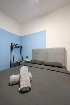 a bedroom with a bed with a towel on it at Blueish Top 2 Palas Horizon brinchang Cameron Highland - C home Luxury B-2-4 in Brinchang