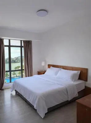 a bedroom with a large bed with a large window at Azure Haven by the Sea-Lumut in Lumut