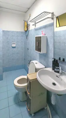 a blue bathroom with a toilet and a sink at Azure Haven by the Sea-Lumut in Lumut