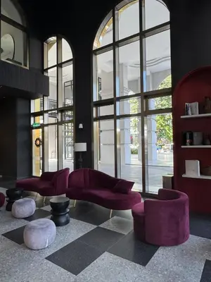 a lobby with purple chairs and large windows at Lovecozy Home 22M Macalister in George Town