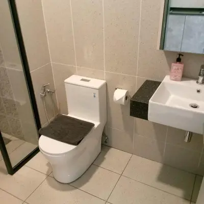 a bathroom with a toilet and a sink at Lovecozy Home 22M Macalister in George Town