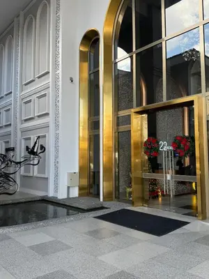 a lobby of a building with a gold revolving door at Lovecozy Home 22M Macalister in George Town