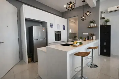 a kitchen with a counter and a refrigerator at Luxury Sea view Sunset view Jazz Suites near Gurney in Tanjong Tokong