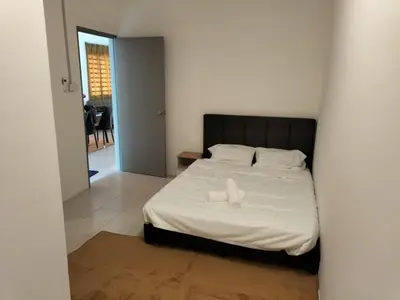 a bedroom with a bed with a black headboard at Lahat Homestay in Lahat