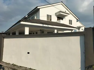 a white house behind a white garage door at Lahat Homestay in Lahat