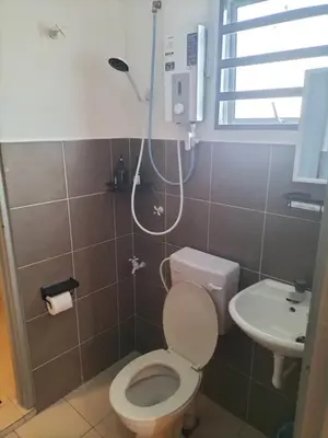 a bathroom with a toilet and a sink at Lahat Homestay in Lahat