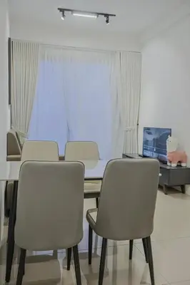 a dining room with a table and four chairs at Picaddily Suites by Homexa Hospitality in Ipoh